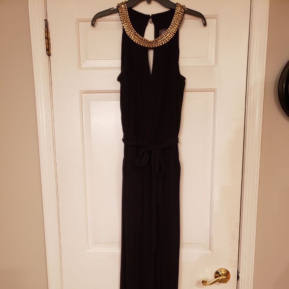 a full length black jumpsuit with a gold neckline